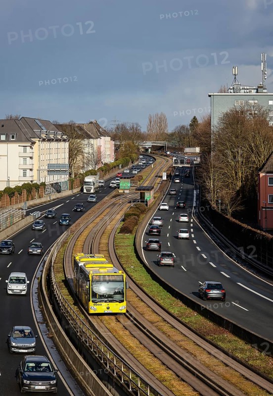 Essen, North Rhine-Westphalia, Germany - Cars and a public bus drive through Essen city centre on the A40 motorway