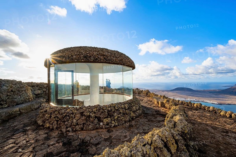 Stairway and viewing platform at the Mirador del Río viewpoint, in the evening light with sun stars, designed by artist César Manrique, view of the island of La Graciosa, Lanzarote, Canary Islands, Spain
