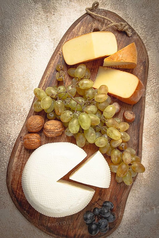 Georgian cheese, Imeretian and smoked suluguni, grapes, nuts, on a cutting board, Georgian cuisine, no people