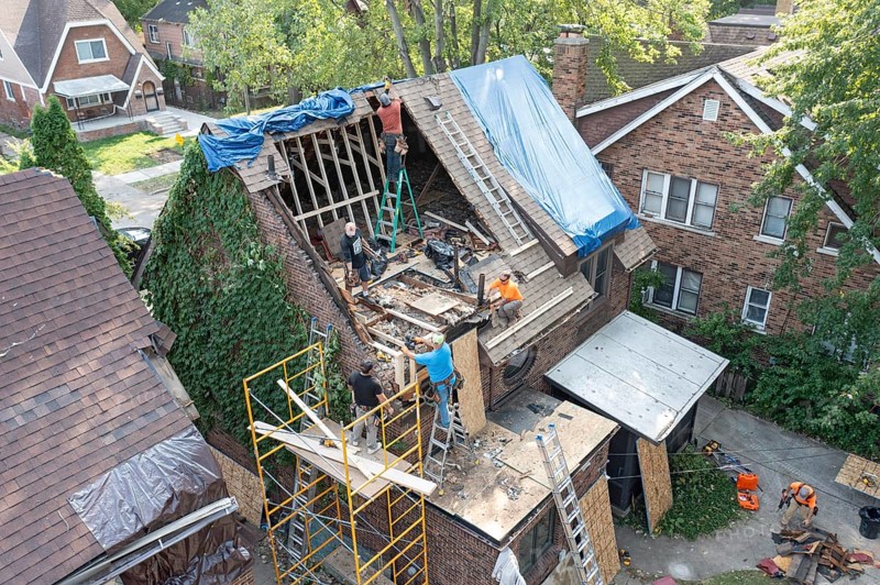Detroit, Michigan, Workers rebuild the attic of a house damaged when a storm blew down a 15-ton, 110-foot cottonwood tree