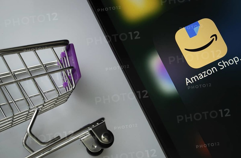 A close up of an iPad screen displaying the amazon shopping app alongside a mini shopping cart