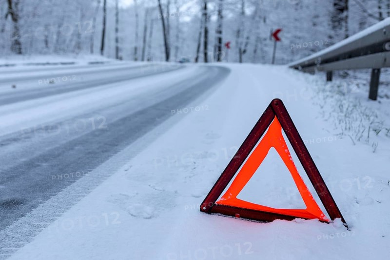 Car left the road in a bend due to snow and ice, Spitzgrund Coswig, Saxony, Germany