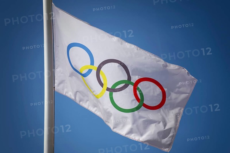 Olympic flag in front of a blue sky
