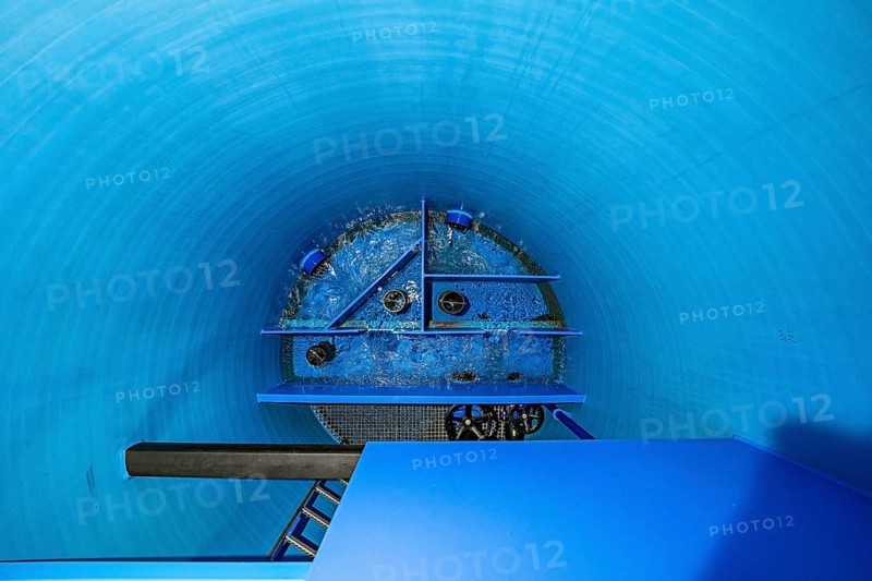 View into a blue cylinder with flowing water and structural elements, ENCW Netze Calw waterworks, Calw, Black Forest, Germany