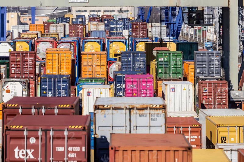 The port of Mannheim is one of Europe's most important inland ports and container terminals. Sea containers are stacked under gantry cranes waiting to be loaded onto lorries and goods trains. Mannheim, Baden-Württemberg, Germany