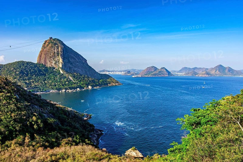 Sugarloaf Mountain and the entrance to Guanabara Bay in Rio de Janeiro with the city of Niteroi and mountains in the background, Rio de Janeiro, RJ, Brazil