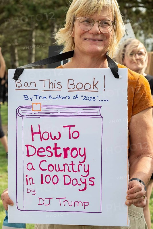 Warren, Michigan USA - 29 April 2025 - Thousands of protesters showed up to 'unwelcome' President Donald Trump who celebrated his first 100 days in office with a rally at Macomb Community College. The protesters cited government funding cuts which have cost jobs, health care, retirement, and more