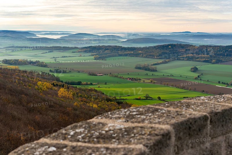 View from the Ith Tower on the Lauensteiner Kopf over the extensive surrounding hilly landscape with green fields and a cloudy sky, Ith-Hils-Weg, Weserbergland, Lower Saxony, Germany