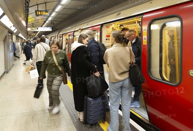 Crowded underground tube train arriving at station platform, Kings Cross Station, London, England, Uk