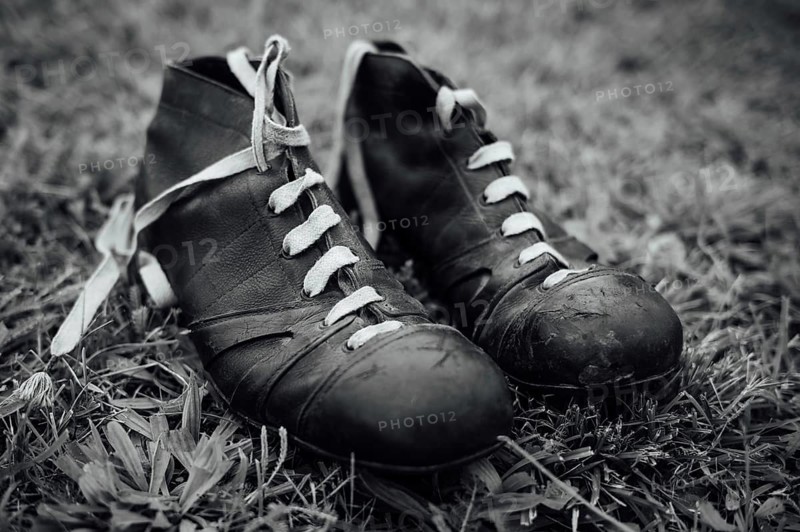Vintage football boots on grass