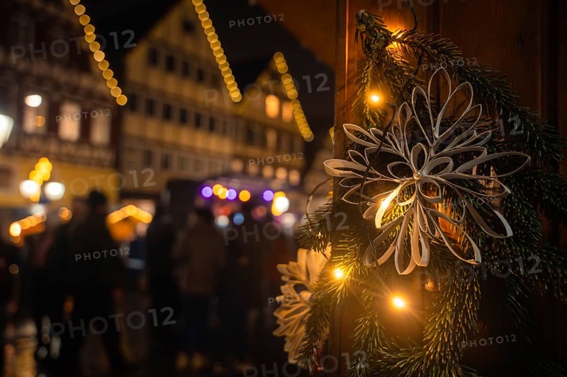 Close-up of a Christmas decoration at night with illuminated traditional houses behind, Christmas market Calw, Black Forest, Germany