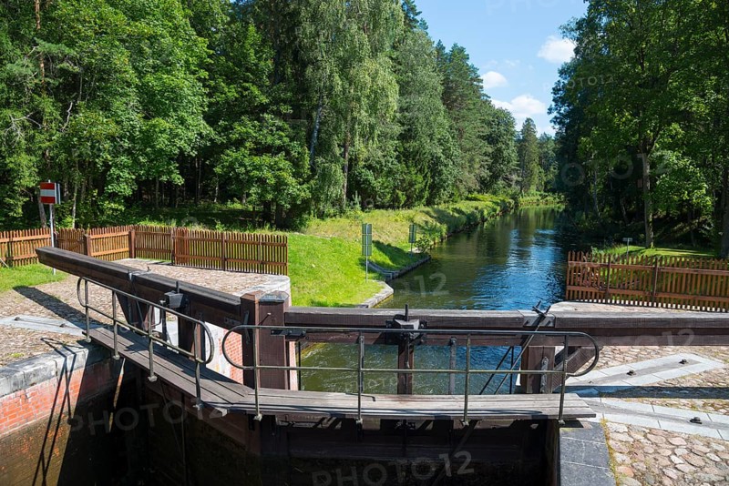 Wooden mechanism of the lock on the waterway through a green forest area, Sluza Perkuc, Perkuc lock, Kanal Augustowski, Augustów Canal, Augustow, canal, Plaska, Plaska, Powiat Augustowski, Podlaskie Voivodeship, Poland