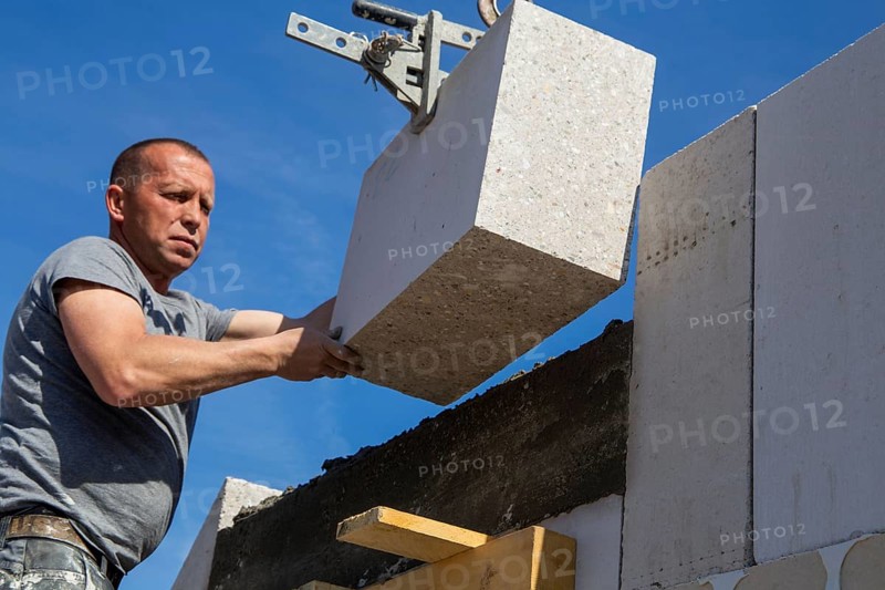 Bricklayer works on a new detached house