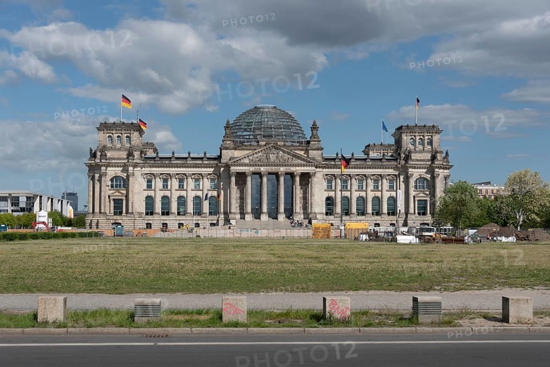 Front view of the Reichstag with a street in the foreground, under a cloudy sky, Berlin, Germany