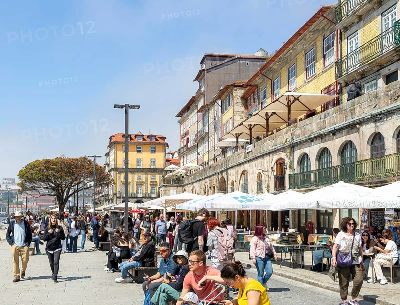 Crowds of tourists on River Douro waterfront of Ribeira district, city of Porto, Portugal