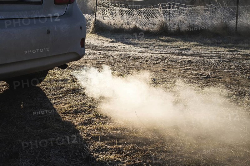 Exhaust fumes from a passenger car exhaust pipe