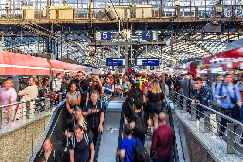 Cologne Central Station. Stairs to the platforms. Travellers waiting for their train on the platform. Crowd with motion blur. Cologne, North Rhine-Westphalia, Germany