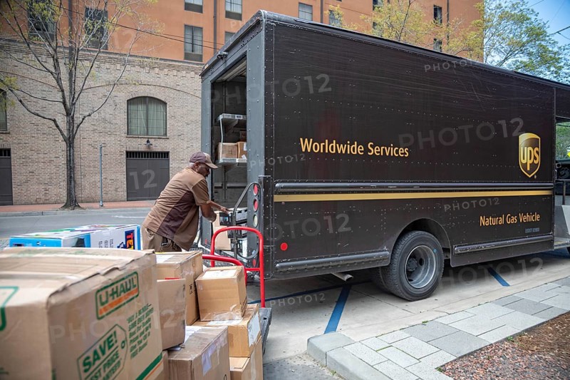 New Orleans, Louisiana - A United Parcel Service driver loads packages into his 'package car' at the New Orleans Convention Center. His vehicle is powered by natural gas