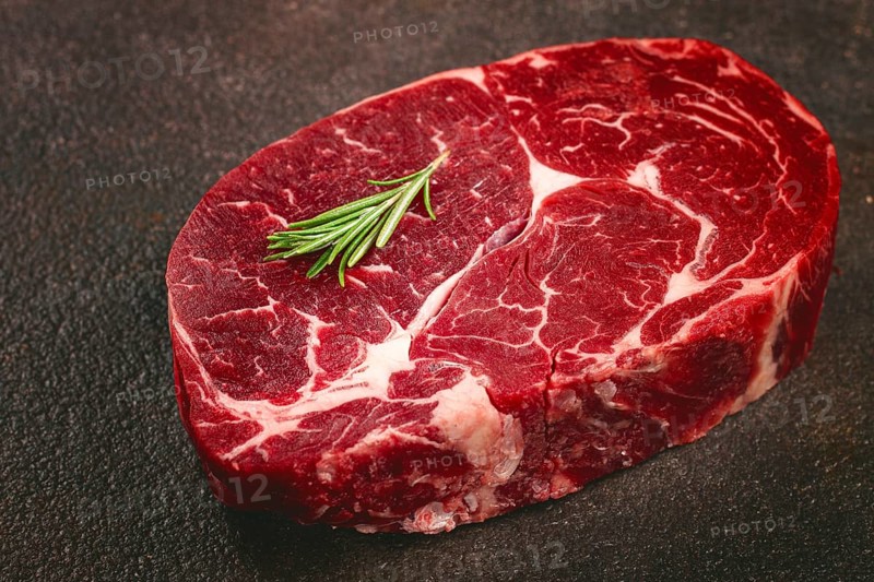 Fresh beef steak, close-up on a dark background, no people