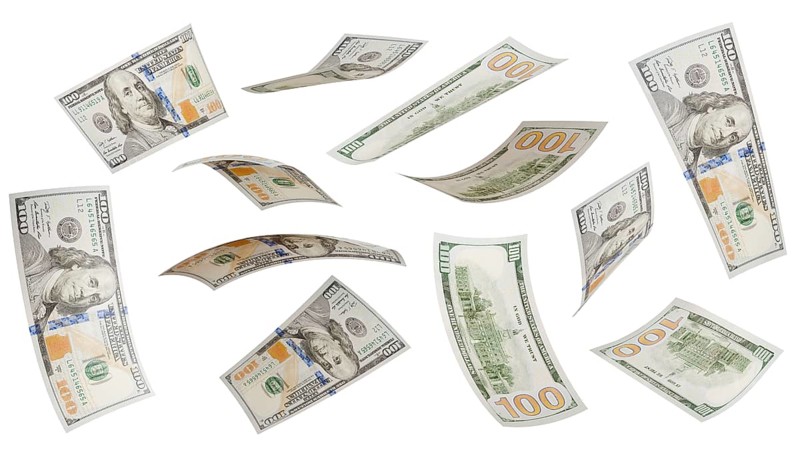 Collection of falling one hundred dollar bills isolated on a white background