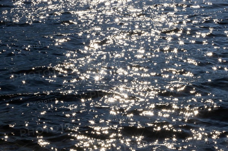 Sunbeams reflect glittering on water surface with high waves, Abstract background, Graphic elements, Mondsee, Salzkammergut, Austria
