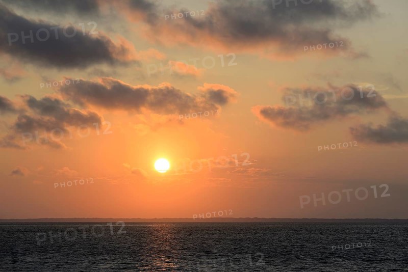 Sunset over the North Sea, on the horizon the contours of the island of Juist, Norddeich, Lower Saxony, Germany