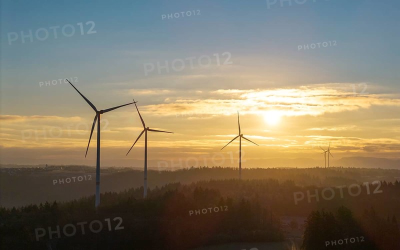 Sunrise with wind turbines in a wooded hilly landscape, Rems Valley, Baden-Württemberg, Germany