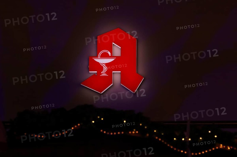 Night shot, logo, red neon sign, pharmacy sign with Aesculapian staff, Aesculapian staff, Christmas decoration, Christmassy, Stuttgart, Baden-Württemberg, Germany