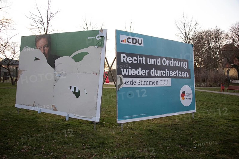 Two election posters of the CDU and the Greens on a lawn with bare trees, Biederitz, Saxony-Anhalt, Germany