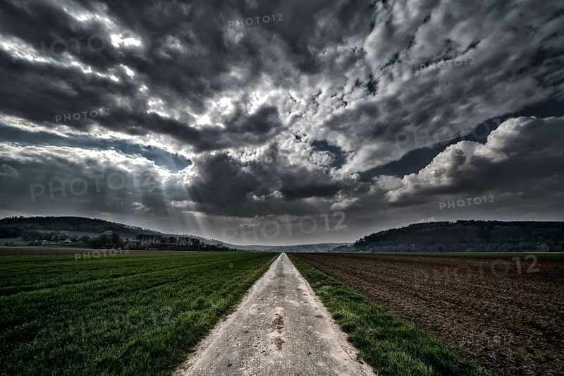 Bike path R1 with a dramatic cloudy sky, near Wesertal, Weser Uplands, Weserbergland, Hesse, Germany, digitally edited