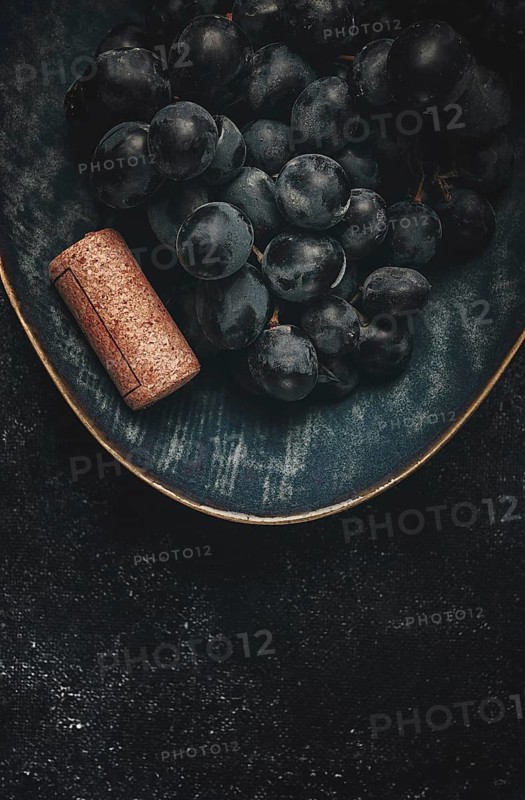 Bunch of black grapes, in a bowl with a wine stopper, Saperavi grape variety, Georgian culture, top view, food concept, no people