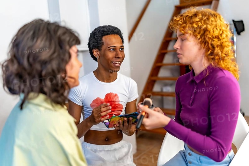 Lgtb multi-ethnic group of friends making up and talking together at home before party