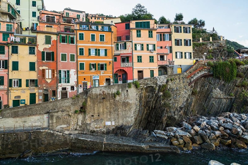Colourful residential apartment buildings and bay in Riomaggiore village, Cinque Terre, La Spezia province, Italy