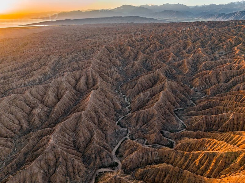 Landscape of eroded hills at Lake Issyk Kul, Badlands at sunrise, aerial view, Canyon of the Forgotten Rivers, Issyk Kul, Kyrgyzstan
