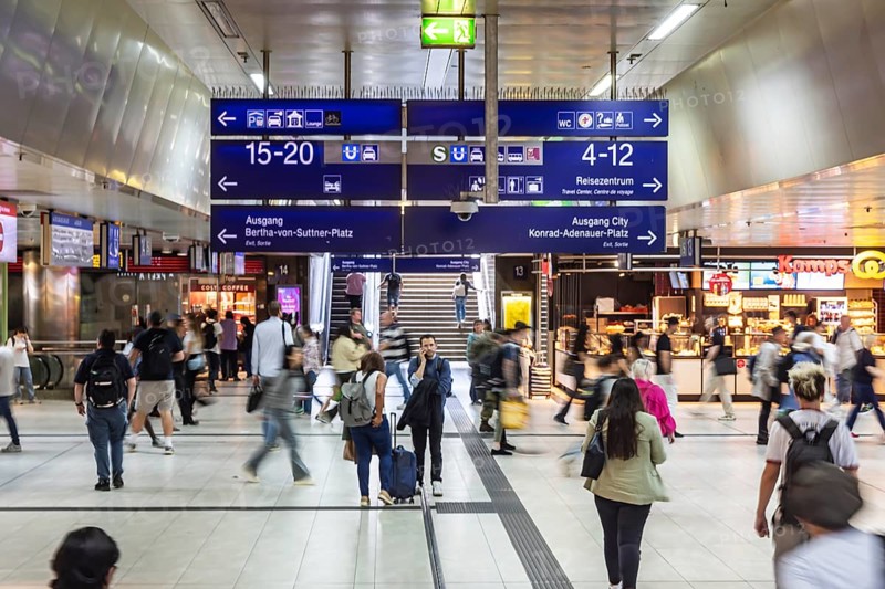 Düsseldorf railway station, station concourse with travellers and signposts. Düsseldorf, North Rhine-Westphalia, Germany