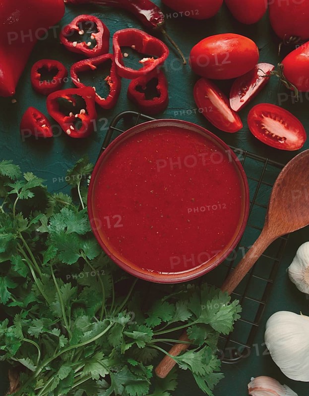 Tomato sauce, tomatoes and sweet pepper, Georgian Satsebeli sauce, with ingredients on a dark background, top view, close-up, no people