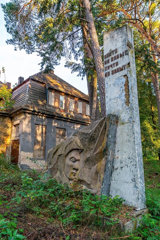 Stele with Cyrillic letters and relief of a soldier in front of the ruins of the officers' house, lost place of the officers' mess at the Wünsdorf military base, former headquarters of the Soviet Army High Command, Zossen, Fläming, Brandenburg, Germany