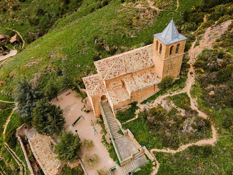 Close-up of a small stone church on a green hill surrounded by paths and trees, aerial view, Las Peñas de Riglos, As Penyas de Riglos, Huesca, Aragon, Spain