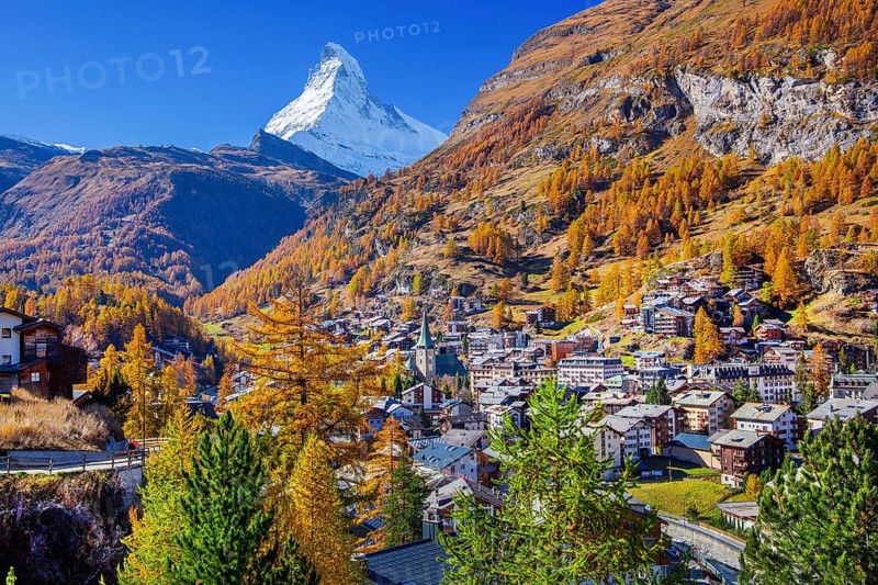 View of the village with Matterhorn 4478m and golden yellow larches in autumn, Zermatt, Mattertal, Valais, Switzerland