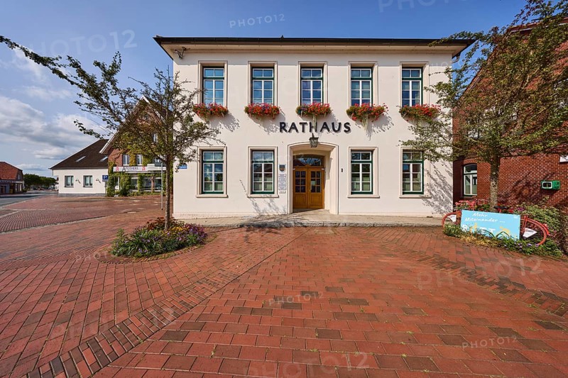 Town hall, flagpoles, blue sky, Ohrbült street, Zetel, district of Friesland, Lower Saxony, Germany
