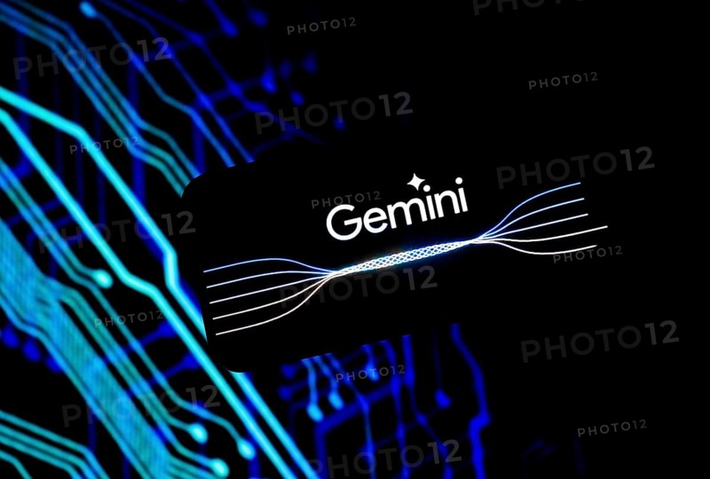 Guwahati, India. 8 December 2023. In this photo illustration a Gemini logo is displayed on a smartphone in front of a display in the background