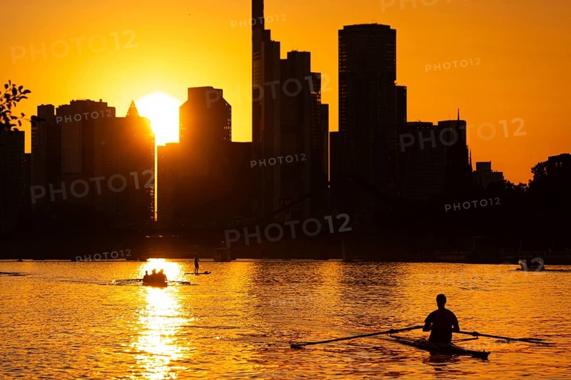 The sun sets behind the Frankfurt banking skyline, Frankfurt am Main, Hesse, Germany