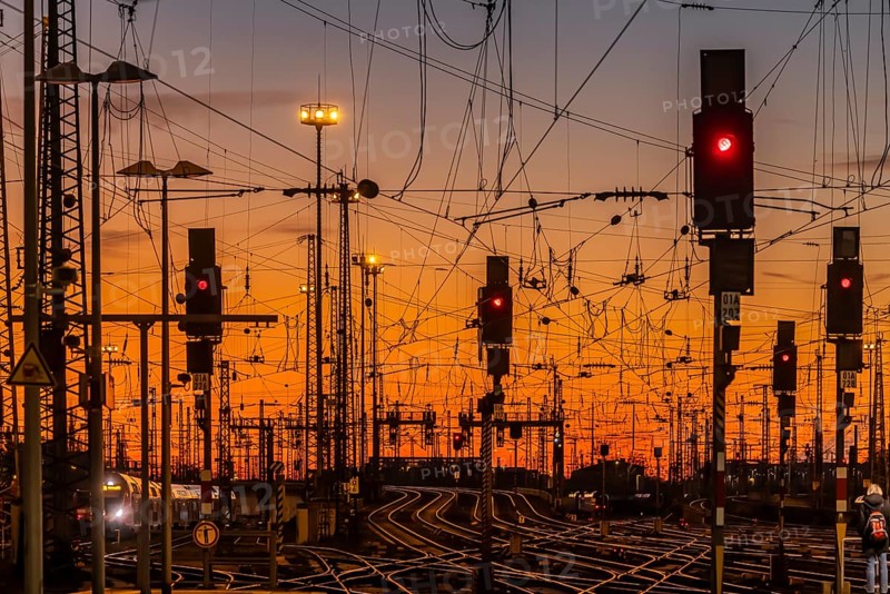 Track apron with trains, rails, points, pylons and signalling systems. Infrastructure at the main station. Sunset. Frankfurt am Main, Hesse, Germany