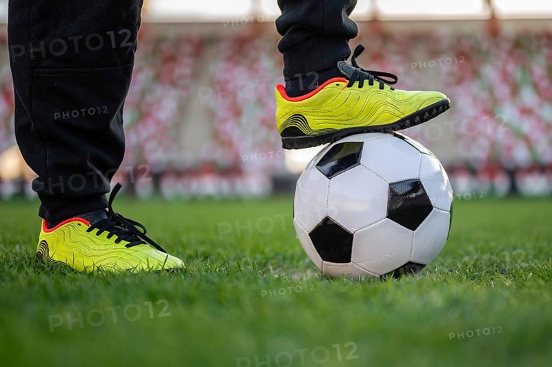 Soccer ball and leg of young player on the ball