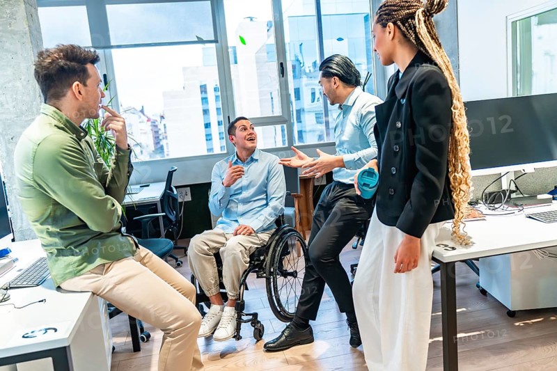 Business colleagues engaging in a productive discussion, demonstrating teamwork and inclusion in a contemporary office setting