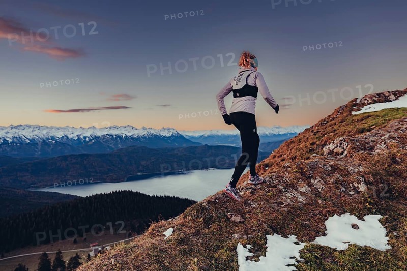 Trail running in autumn on the Jochberg on Lake Walchensee against the wonderful backdrop of the Alps, Bavaria, Germany