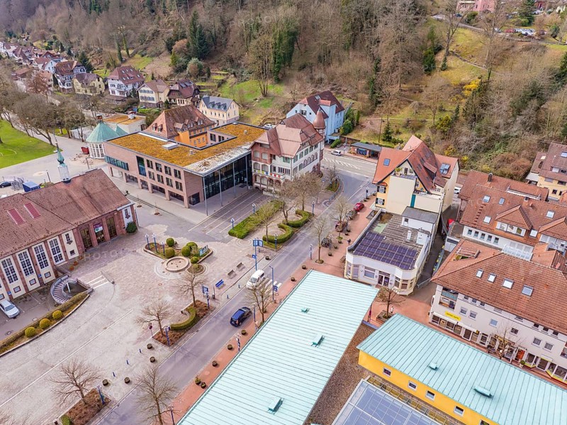 Aerial view of a quiet village street with colourful roofs and surrounded by a wooded mountain landscape, Bad Liebenzell, district of Calw, Germany