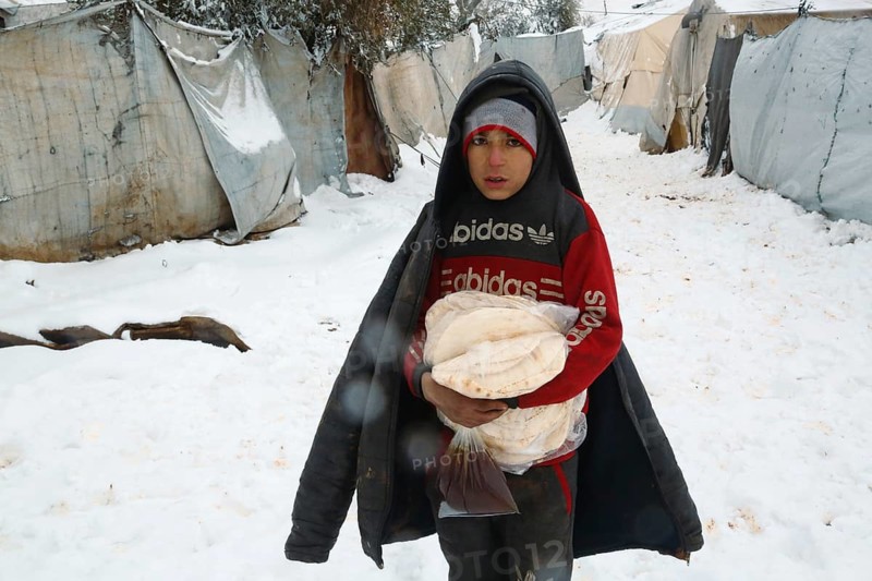 Displaced Syrian families and children living in refugee camps during harsh winter conditions, facing snow, cold weather, and difficult humanitarian circumstances. Aleppo, Syria January 01, 2022, Aleppo, Syria