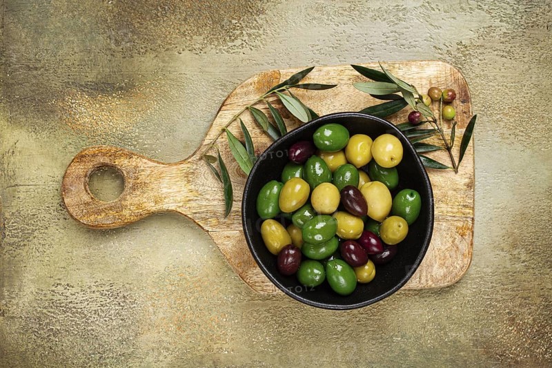 A mixture of olives, varieties of chalkidiki, Verdi giganti and Kalamata, in a bowl, top view, no people