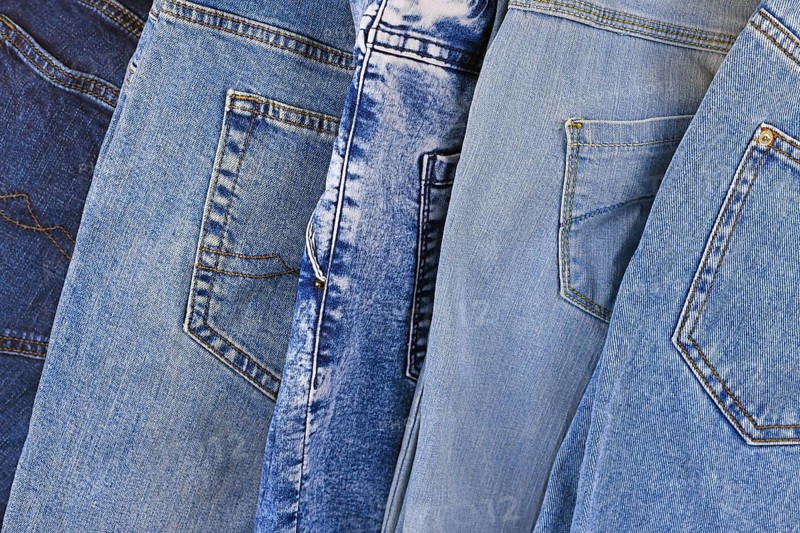 Top view of different colored blue jeans pants